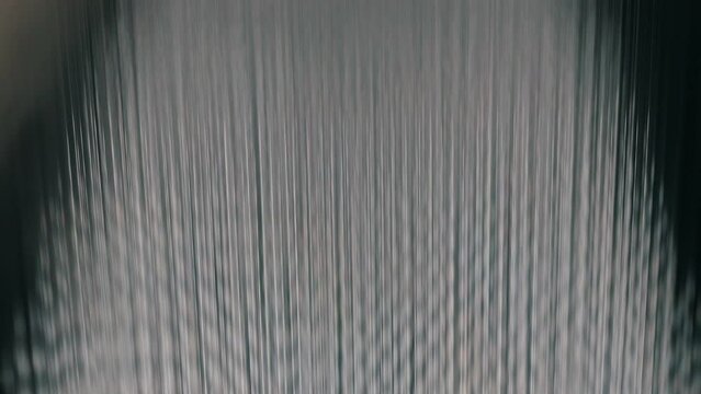 Large roll of synthetic winterizer. Syntepon manufacturing process. Industrial interior.