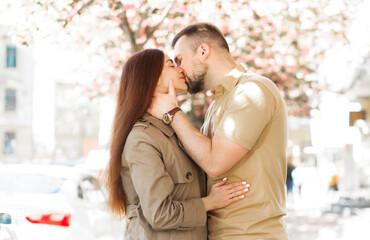 Spring couple in love. Kissing couple in spring nature close-up portrait.