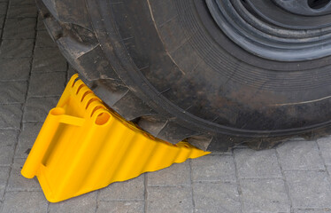 wheel chock under the wheel of a car