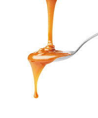  drip of caramel in a spoon on a white background - obrazy, fototapety, plakaty