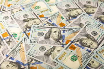 Money, US hundred dollar bills background. Money is scattered on the table. Finance and economics concepts.Money accumulation concept.Currency saving.Investment.Copy space.Close-up.