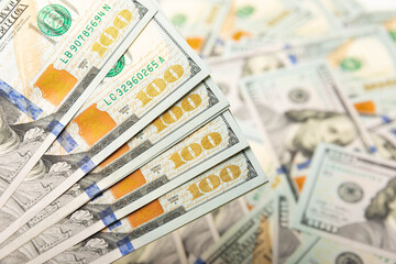 Money, US hundred dollar bills background. Money is scattered on the table. Finance and economics concepts.Money accumulation concept.Currency saving.Investment.Copy space.Close-up.