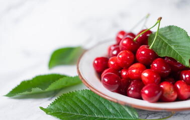 freshly picked cherries in metal plate