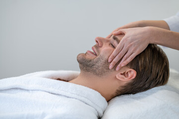 Fototapeta na wymiar Close up of a man having face massage