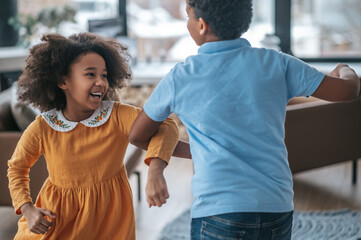 A boy and a girl dancing and looking joyful