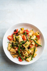 Pasta salad with grilled vegetables, zucchini, eggplant, asparagus and tomatoes.