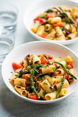 Pasta salad with grilled vegetables, zucchini, eggplant, asparagus and tomatoes.