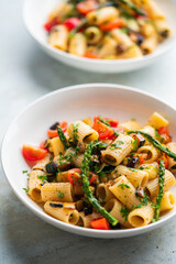 Pasta salad with grilled vegetables, zucchini, eggplant, asparagus and tomatoes.
