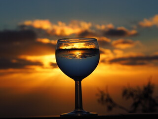 glass of red wine against sunset