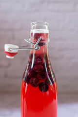bottle of homemade blueberry kombucha drink on marble floor, fermented tea drinks