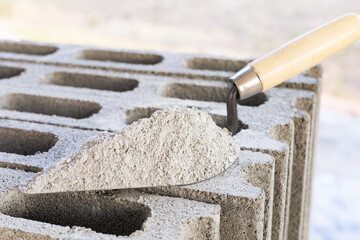 Cement or mortar, Cement mix or cement powder with a trowel put on the brick for construction work. - obrazy, fototapety, plakaty