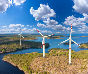 Fototapeta na wymiar Electric turbines on shore of lake. Wind turbines generate electricity. Green energy concept. Getting electricity. Windmills view from quadrocopter. Wind turbines are rotated by wind.