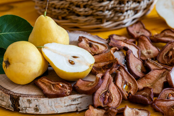 Slices of dried pears, delicious snack, healthy food, close-up on a wooden background