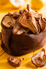 Slices of dried pears, delicious snack, healthy food, close-up on a wooden background