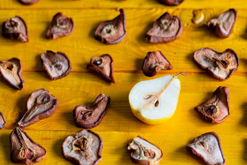 Slices of dried pears, delicious snack, healthy food, close-up on a wooden background
