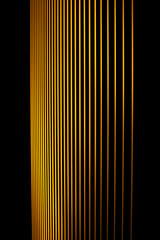 vertical straight yellow fresh line graphic pattern on dark black background