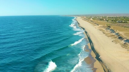 Fototapeta na wymiar 2021:TODOS SANTOS BCS MEXICO.The Beautiful View Of Blue Sea Waves Touching The Beach Sand