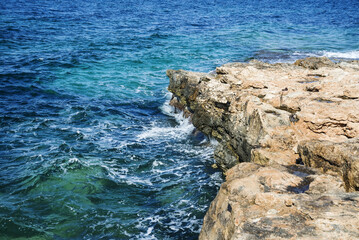 blue greek sea with rocky shore