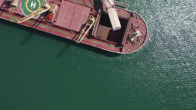Cargo ship with cranes for loading containers, aerial 
Drone view from , Israel, Ashdod,June,07,2022, freight shipping concept
