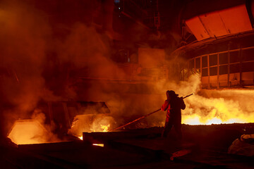 Steel foundry worker at blast furnace workshop.