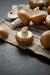 Close up of raw fresh champignon mushrooms on kitchen textile