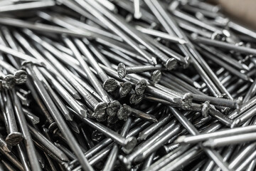 Iron nails in a box. Lots of metal products in the warehouse. - obrazy, fototapety, plakaty