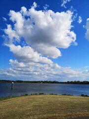 Beautiful clear blue sky with white clouds over the mesh