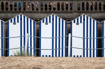 White and blue cabanas on the beach in Cabourg in Normandy, symbol of the city