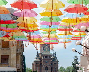 View an Orthodox Romania church below umbrellas