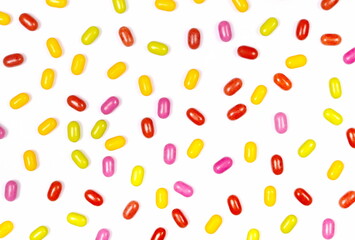 Colorful candies isolated on white texture, top view