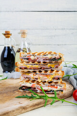 Sandwich with ham, cheese, mustard leaves, tomatoes and onion. Tasty grilled sandwiches