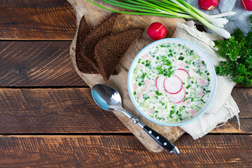 Summer cold soup with yogurt and vegetables. Traditional russian cold soup okroshka. Top view