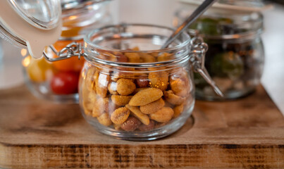 Glass jars with healthy party snacks served in bar, tasty appetisers