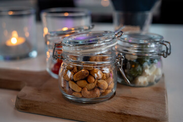 Glass jars with healthy party snacks served in bar, tasty appetisers