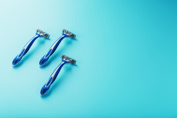 Blue shaving machines in a row on a blue background