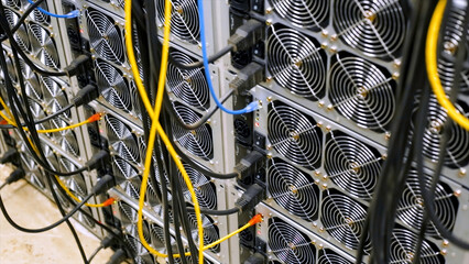 Wall of data centers and wires. Stock footage. Lots of units with data center fans and hanging...