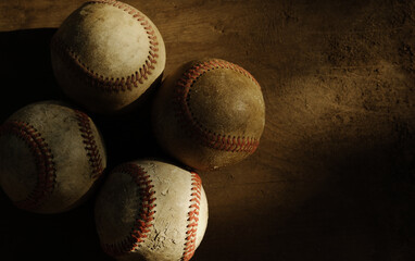 Old vintage style baseball background with used balls from sports game and wood texture backdrop for wallpaper.
