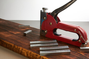 construction stapler with staples on the board