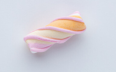 Colorful marshmallows on pastel background.