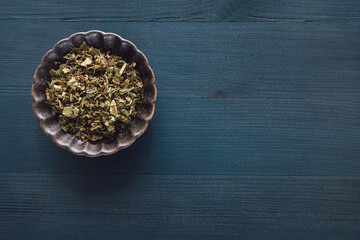 Ceramic Bowl of Patchouli on Blue Stained Wood