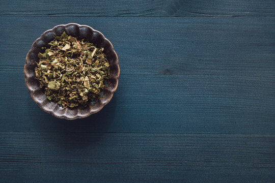 Ceramic Bowl of Patchouli on Blue Stained Wood