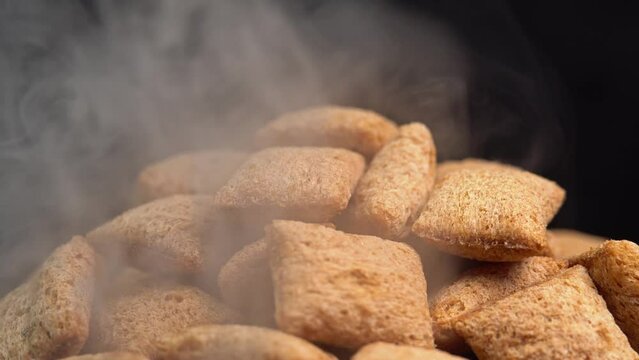 Hot crispy chocolate pads rotation with smoke in macro