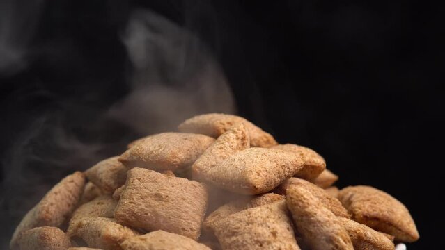 Hot crispy chocolate pads rotation with smoke in macro