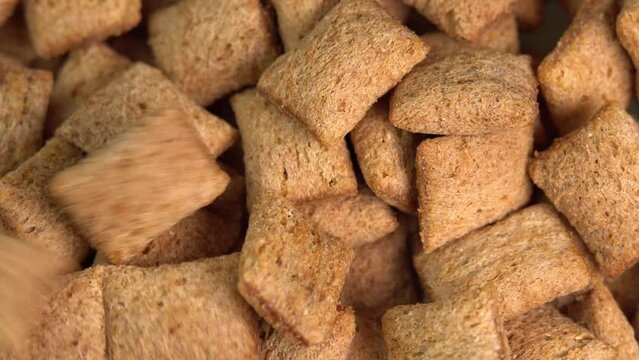 Crispy chocolate pads falling down macro. Cocoa cereal