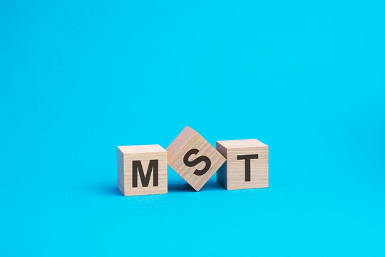 mst text on wooden blocks, business concept, blue background