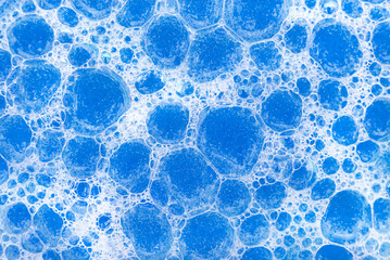 Soap foam. Background of dusty foam with bubbles of blue color for an inscription. Soap sud with copy-space