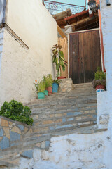 Fototapeta premium typical streets and traditional houses with nice doors and flowers in the city of Berat, Albania