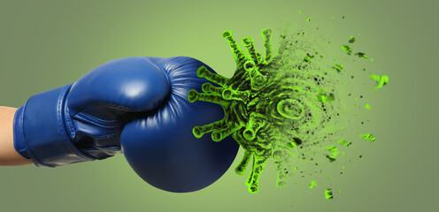 Hand in boxing glove kicking cigarette on green background. Concept of immunity - obrazy, fototapety, plakaty