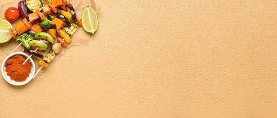 Parchment with tasty vegetable skewers and spices on color background with space for text