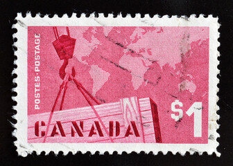 Cancelled postage stamp printed by Canada, that shows Export Trade - Crane and world map, circa...